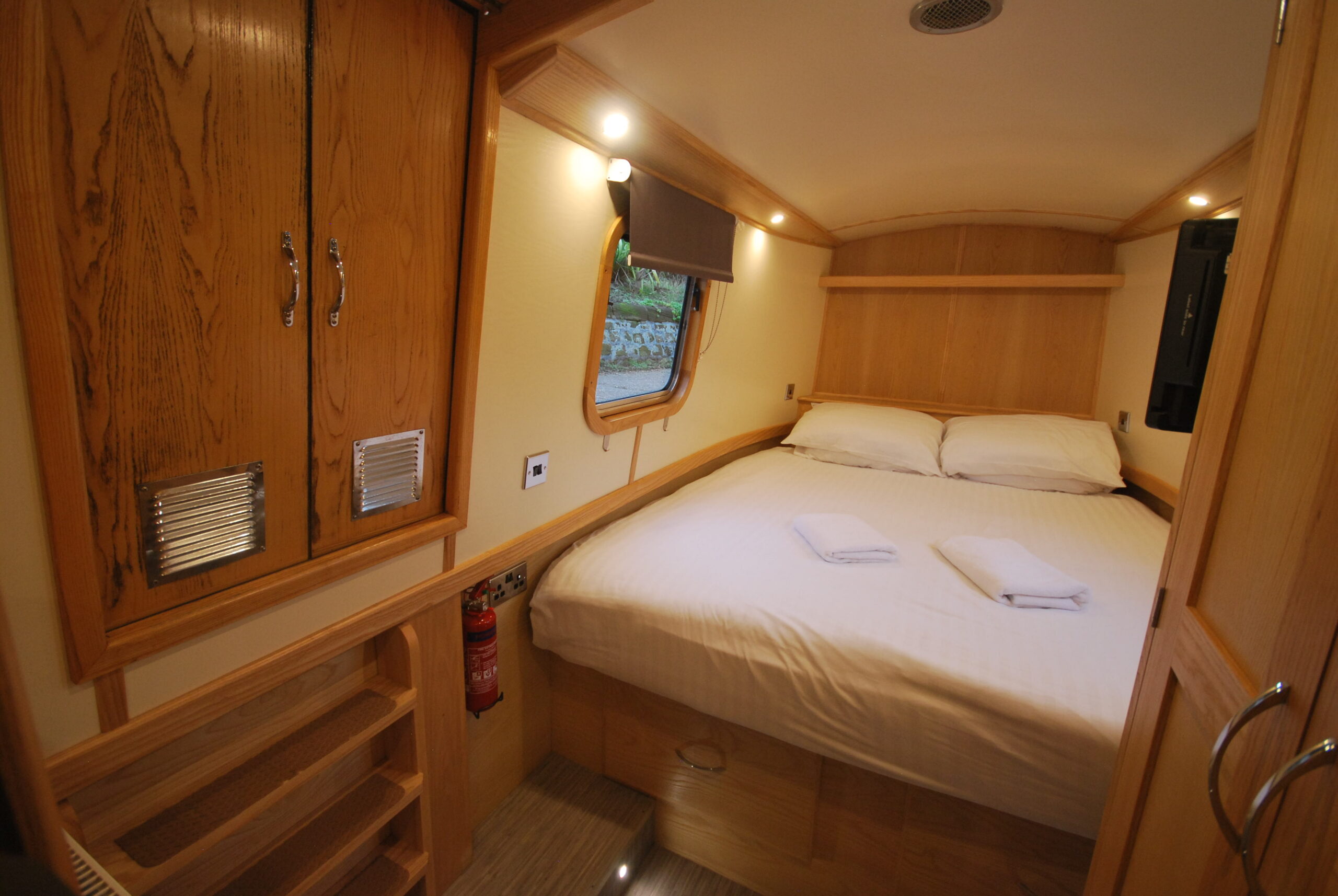 King size bed on a narrow canal boat
